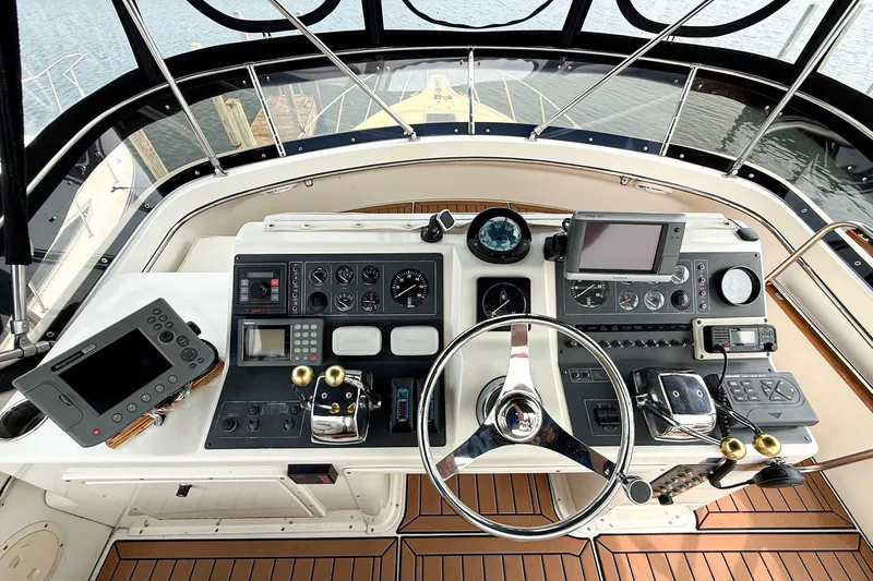 Slide: The Image of Cockpit of 1989 Tiara Yachts 3600 Convertible with navigation instruments and steering wheel. - 19