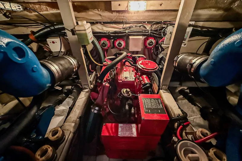 Slide: The Image of Engine room of 1989 Tiara Yachts 3600 Convertible, showcasing mechanical components. - 49