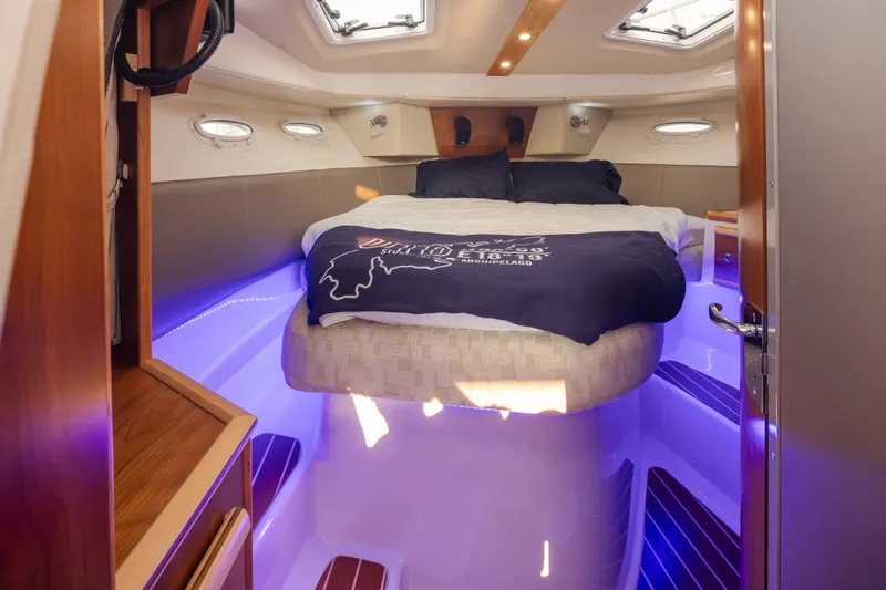 Slide: The Image of 2023 Cutwater C-30 Sedan cabin interior with bed and ambient lighting. - 37