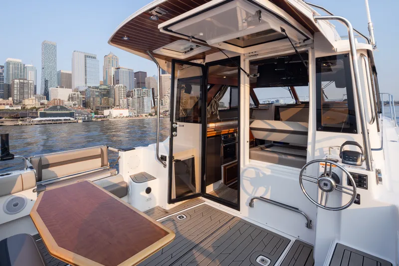 Slide: The Image of 2023 Cutwater C-30 Sedan yacht with city skyline backdrop, featuring elegant interior and deck. - 48