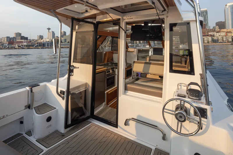 Slide: The Image of 2023 Cutwater C-30 Sedan boat interior with city skyline in the background. - 21