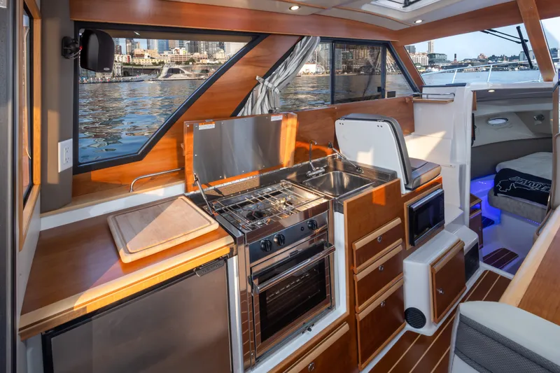 Slide: The Image of Interior of 2023 Cutwater C-30 Sedan yacht featuring modern kitchen amenities. - 29
