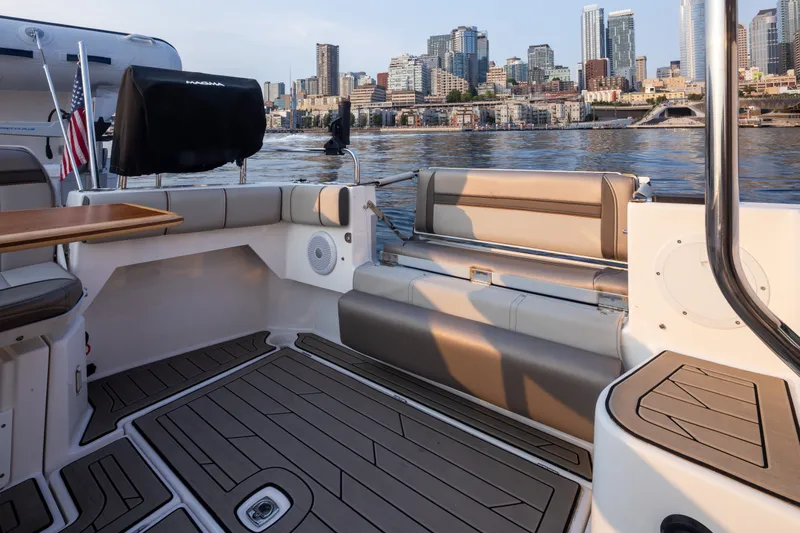 Slide: The Image of 2023 Cutwater C-30 Sedan boat interior with city skyline in the background. - 22