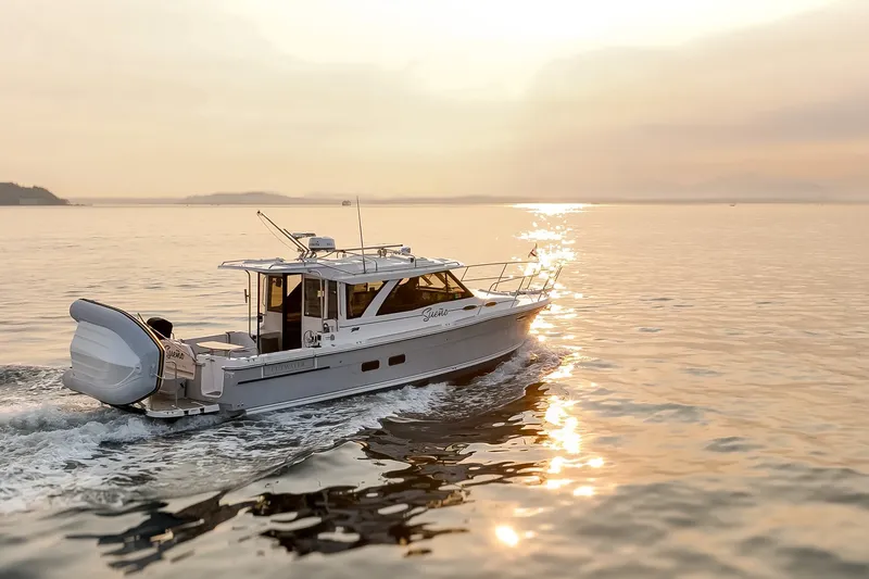 Slide: The Image of 2023 Cutwater C-30 Sedan cruising on serene waters at sunset. - 13