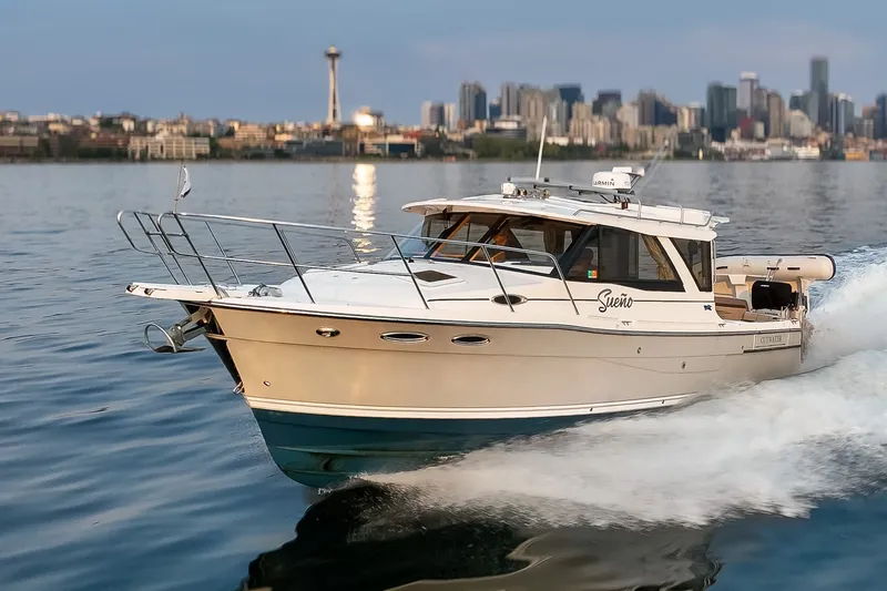 Slide: The Image of 2023 Cutwater C-30 Sedan cruising on water with city skyline in background. - 18