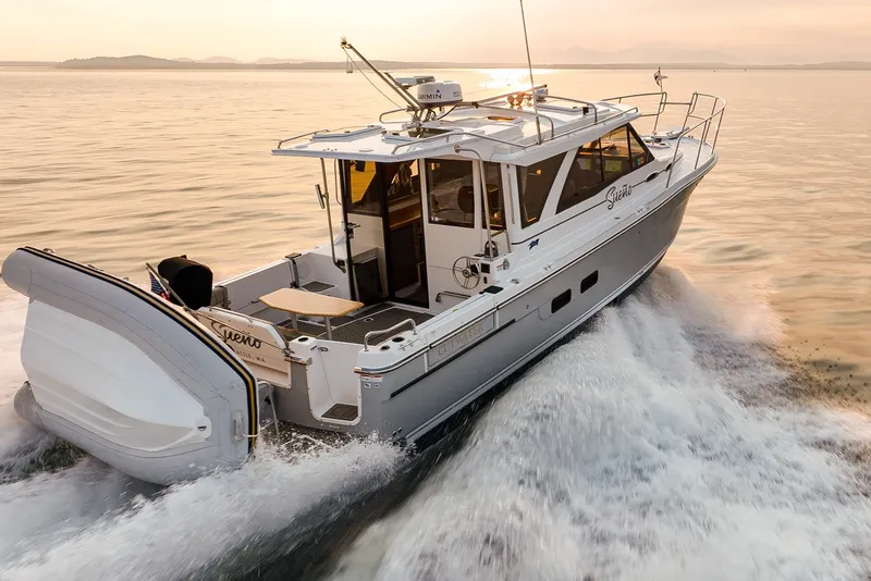 Slide: The Image of 2023 Cutwater C-30 Sedan cruising on open water at sunset. - 50