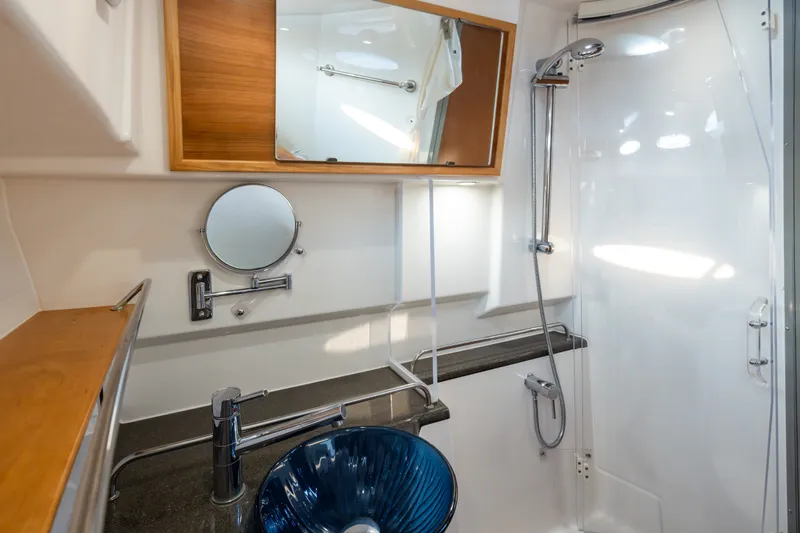 Slide: The Image of Modern bathroom in 2023 Cutwater C-30 Sedan yacht with sleek fixtures and glass sink. - 40