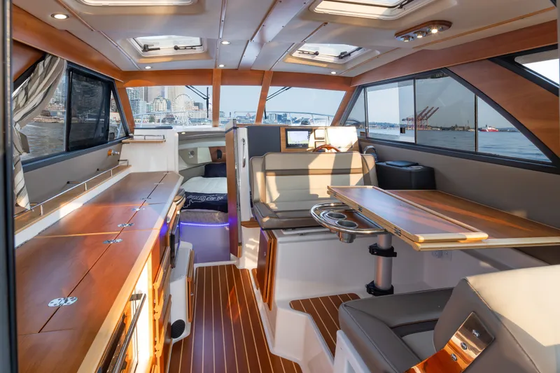Slide: The Image of 2023 Cutwater C-30 Sedan interior with elegant wood finishes and waterfront views. - 26