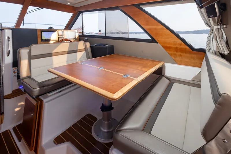 Slide: The Image of Interior of 2023 Cutwater C-30 Sedan with elegant seating and wooden table. - 25