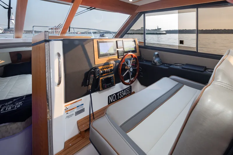 Slide: The Image of Interior of 2023 Cutwater C-30 Sedan boat with modern dashboard and steering wheel. - 34