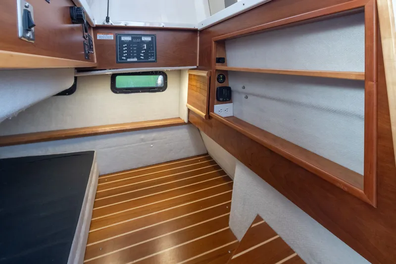 Slide: The Image of 2023 Cutwater C-30 Sedan interior cabin with wood accents and modern amenities. - 42