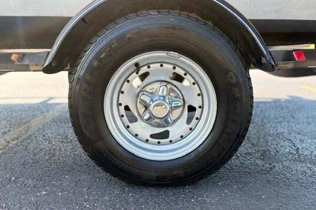 Slide: The Image of Trailer wheel of 2012 TRACKER BOATS Pro Team 175, featuring Carlisle radial tire. - 48