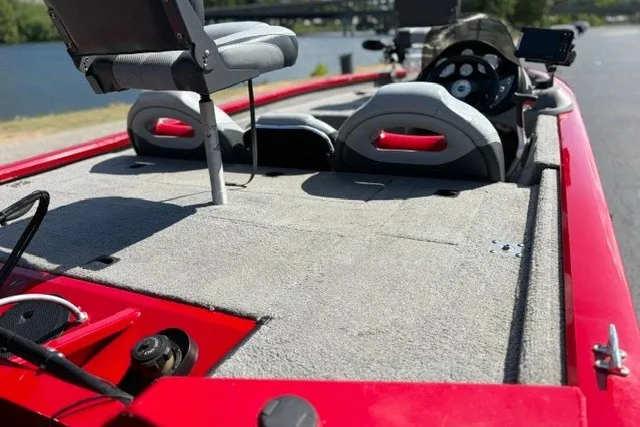 Slide: The Image of 2012 TRACKER BOATS Pro Team 175 with red exterior, spacious deck, and comfortable seating. - 60