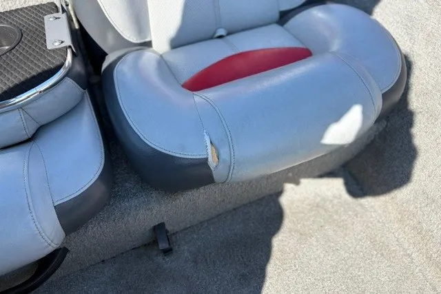 Slide: The Image of Torn seat on 2012 TRACKER BOATS Pro Team 175, gray and red upholstery. - 16