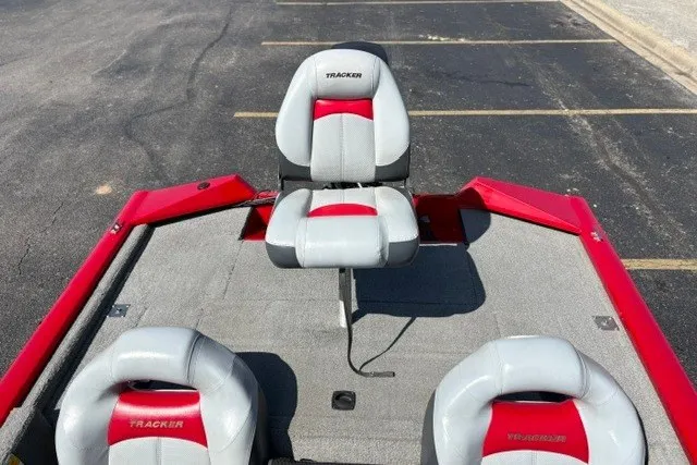 Slide: The Image of 2012 TRACKER BOATS Pro Team 175 with red and gray seating on a parking lot. - 29