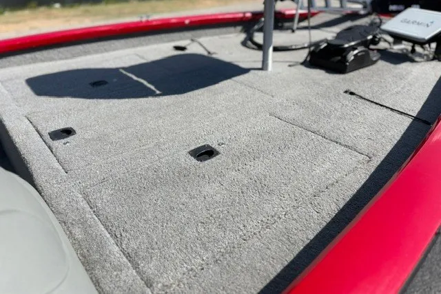 Slide: The Image of 2012 TRACKER BOATS Pro Team 175 deck with carpeted surface and storage compartments. - 64