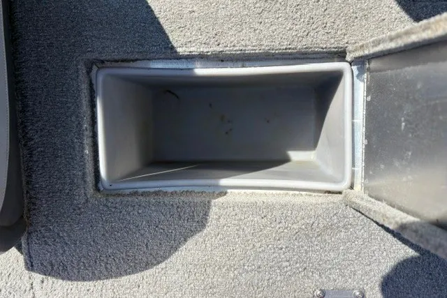 Slide: The Image of Storage compartment in 2012 TRACKER BOATS Pro Team 175, featuring carpeted interior. - 22