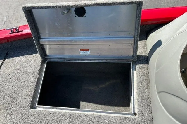 Slide: The Image of Open storage compartment on 2012 TRACKER BOATS Pro Team 175, featuring carpeted interior. - 49