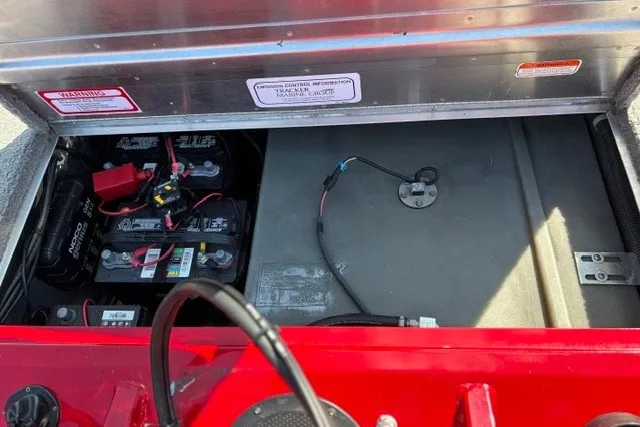 Slide: The Image of 2012 TRACKER BOATS Pro Team 175 battery compartment with wiring and storage area. - 67
