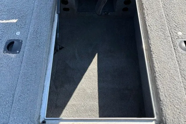 Slide: The Image of 2012 TRACKER BOATS Pro Team 175 storage compartment, carpeted interior, open hatch view. - 19