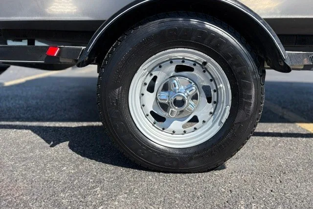 Slide: The Image of Trailer wheel of 2012 TRACKER BOATS Pro Team 175 on asphalt. - 59