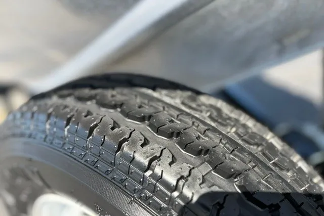 Slide: The Image of Close-up of a tire on a 2012 TRACKER BOATS Pro Team 175 trailer. - 36