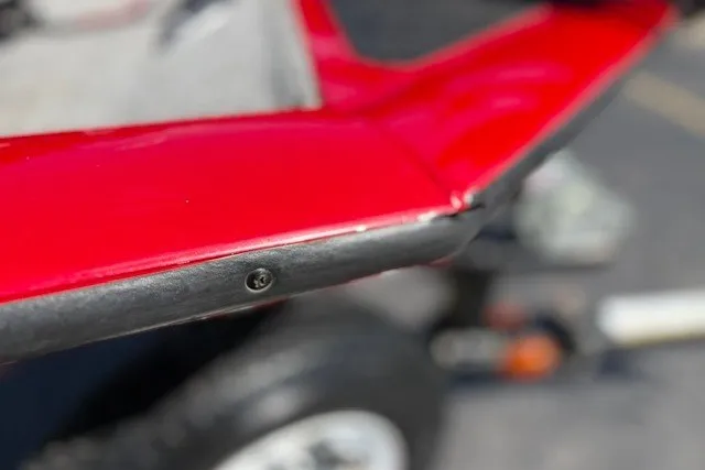 Slide: The Image of Close-up of a 2012 TRACKER BOATS Pro Team 175, showing red hull detail. - 44