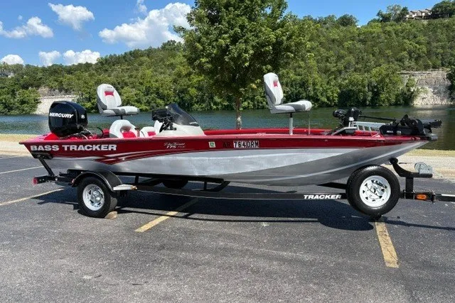 The Image of 2012 TRACKER BOATS Pro Team 175 bass boat parked by a scenic lake. - 6