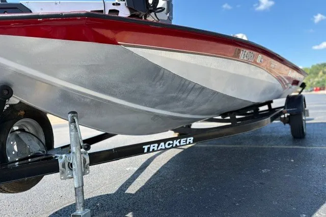 Slide: The Image of 2012 TRACKER BOATS Pro Team 175 on trailer, red and silver hull, sunny day. - 38