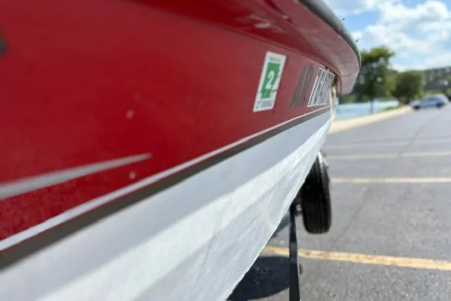Slide: The Image of Red and white 2012 TRACKER BOATS Pro Team 175 in a parking lot. - 34