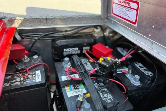 Slide: The Image of Battery compartment of a 2012 TRACKER BOATS Pro Team 175 with NOCO Genius charger. - 58