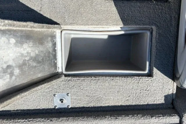 Slide: The Image of Storage compartment in 2012 TRACKER BOATS Pro Team 175, featuring carpeted interior. - 21