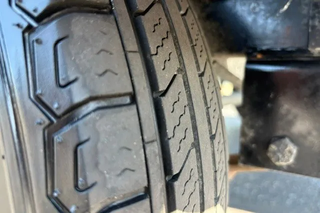 Slide: The Image of Close-up of a tire tread on a 2012 TRACKER BOATS Pro Team 175 trailer. - 63