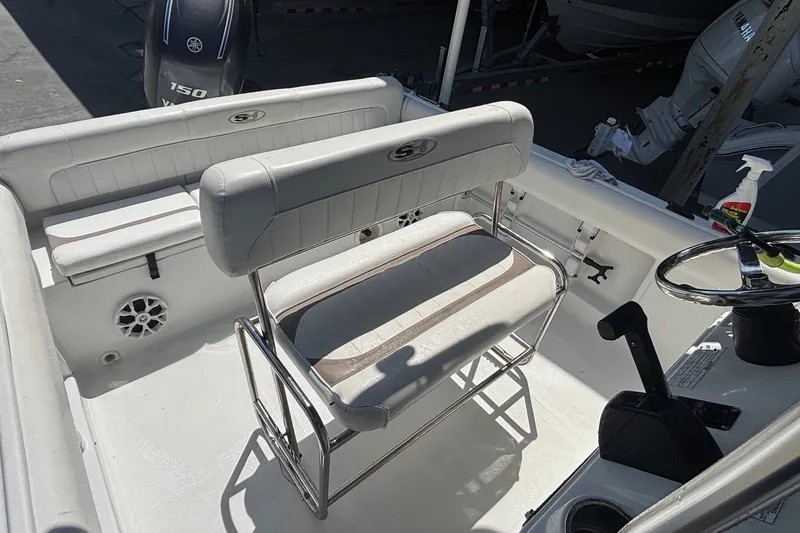 Slide: The Image of 2010 Sea Hunt Ultra 210 boat interior with seating and steering wheel. - 15