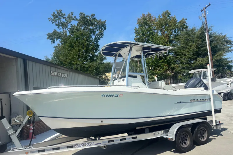 The Image of 2010 Sea Hunt Ultra 210 boat on trailer, parked near service department. - 1