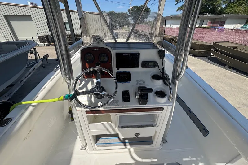 Slide: The Image of 2010 Sea Hunt Ultra 210 boat console with steering wheel and navigation controls. - 16