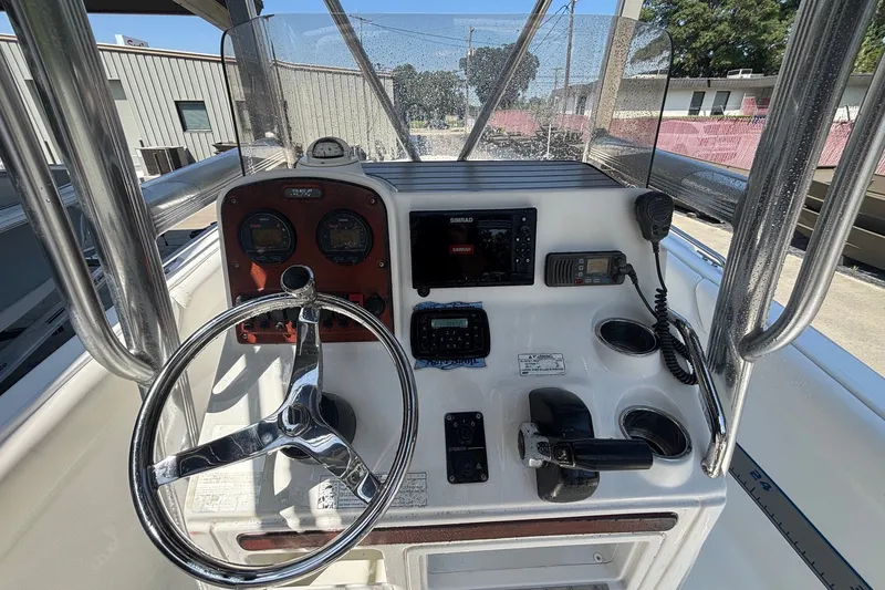 Slide: The Image of 2010 Sea Hunt Ultra 210 boat console with steering wheel and navigation equipment. - 17