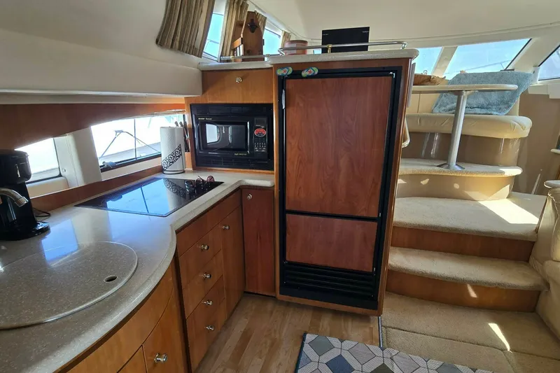 Slide: The Image of Interior of 2002 Carver 410 Sport Sedan yacht with kitchen and dining area. - 7