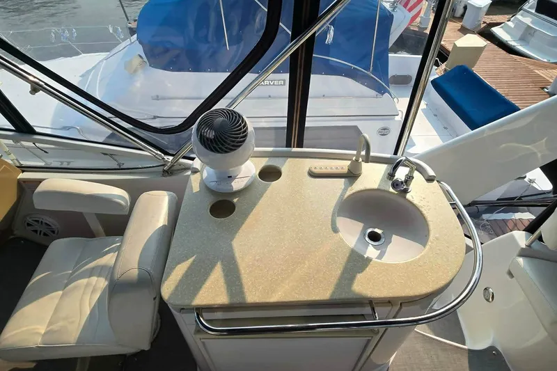 Slide: The Image of 2002 Carver 410 Sport Sedan interior with sink and seating area. - 24