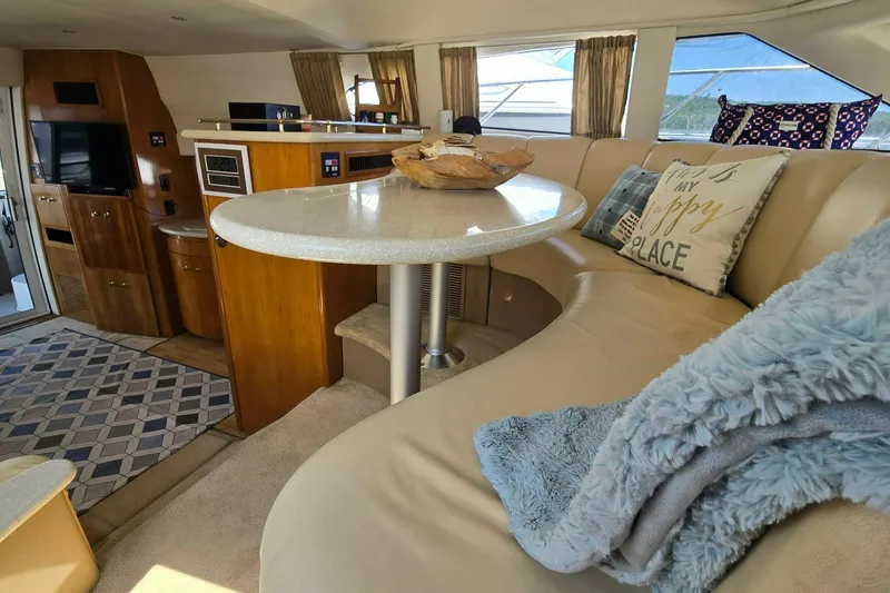 Slide: The Image of Luxurious interior of a 2002 Carver 410 Sport Sedan yacht with cozy seating. - 9