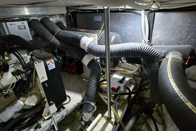 Slide: The Image of Engine room of a 2002 Carver 410 Sport Sedan with visible hoses and machinery. - 30
