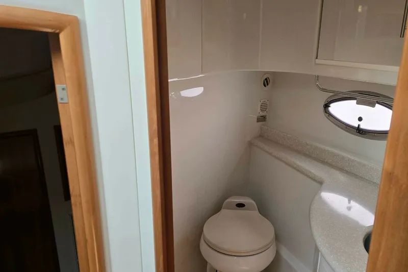 Slide: The Image of 2002 Carver 410 Sport Sedan bathroom interior with compact design and oval window. - 17