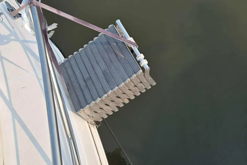 Slide: The Image of Boarding ladder on a 2002 Carver 410 Sport Sedan yacht over water. - 25