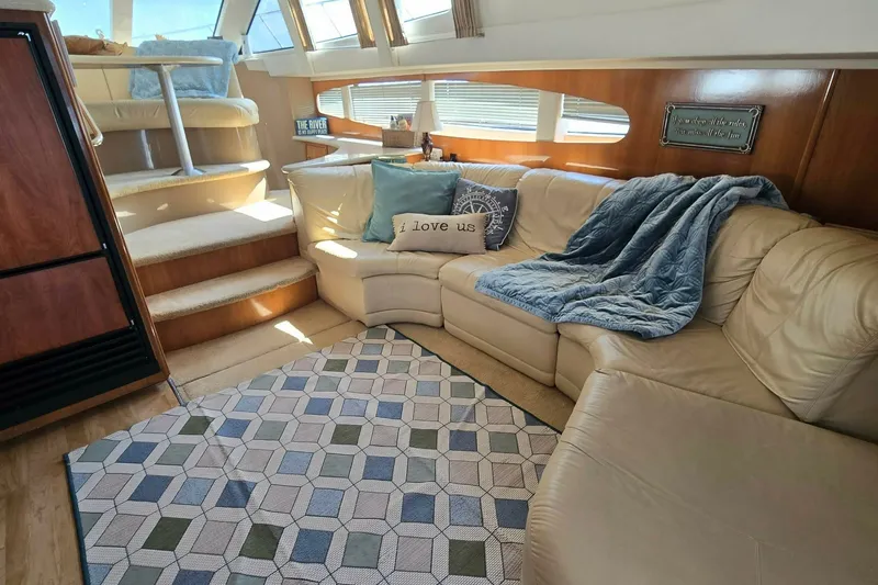 Slide: The Image of Luxurious interior of a 2002 Carver 410 Sport Sedan with cozy seating and nautical decor. - 11