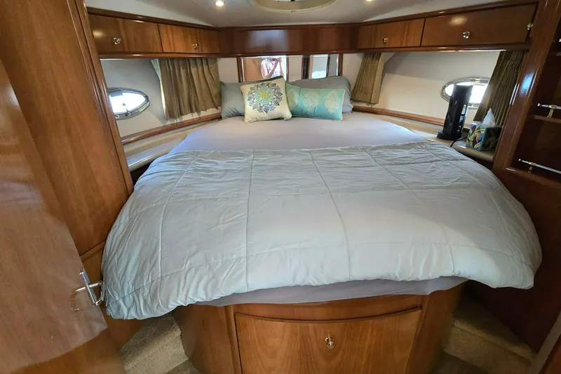Slide: The Image of Luxurious bedroom interior of 2002 Carver 410 Sport Sedan yacht with cozy bedding. - 12