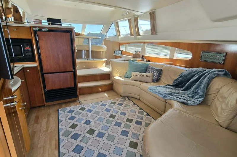 Slide: The Image of Luxurious interior of a 2002 Carver 410 Sport Sedan yacht with cozy seating and modern amenities. - 8