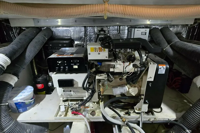Slide: The Image of Engine room of a 2002 Carver 410 Sport Sedan with visible machinery and components. - 31