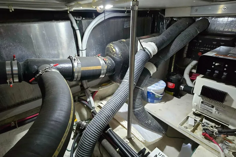 Slide: The Image of Engine room of a 2002 Carver 410 Sport Sedan with visible hoses and equipment. - 29