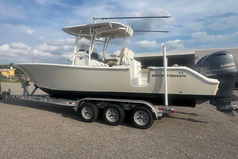 Slide: The Image of 2017 Sportsman Open 282 Center Console boat on a trailer, parked outdoors. - 27