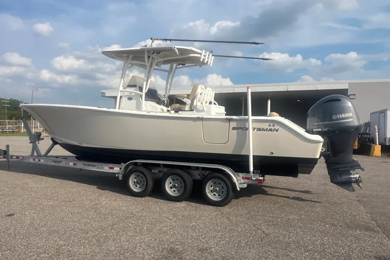 Slide: The Image of 2017 Sportsman Open 282 Center Console boat on trailer, parked outdoors. - 17